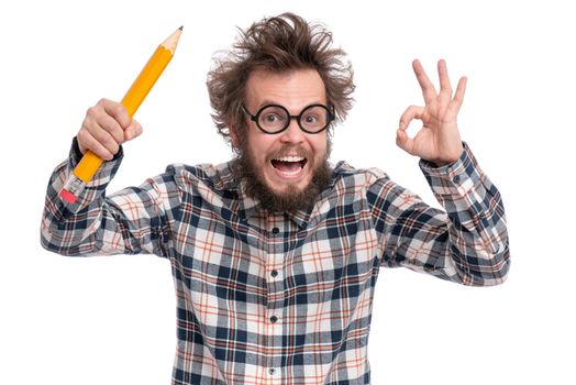 Crazy bearded Man in plaid shirt with funny Haircut in eye Glasses holding Big Pencil and making Ok Gesture, isolated on white background.