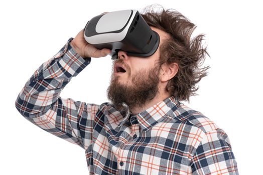 Crazy bearded Man in plaid shirt with funny Haircut wearing virtual reality helmet, isolated on white background. Portrait of funny man using VR goggles.