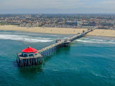 Aerial view of Huntington Pier, beach and coastline during sunny summer day, Southeast of Los Angeles. California. destination for surfer and tourist.