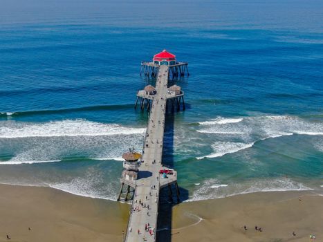 Aerial view of Huntington Pier, beach and coastline during sunny summer day, Southeast of Los Angeles. California. destination for surfer and tourist.