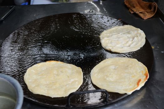 Soft focus of Fried Roti on a hot frying pan