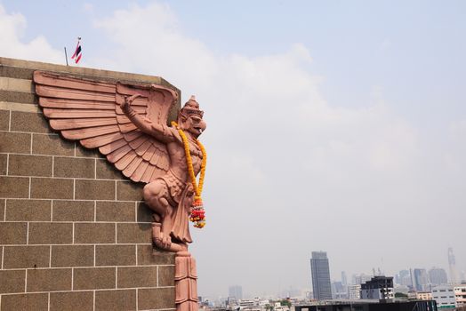 Soft focus of Big Garuda statue on public skyscraper, Bangkok, Thailand