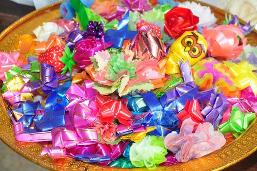 almsgiving with ribbon-flowers for giving alms to make merit in Buddhism religious traditional in Thailand