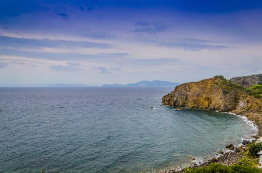 rocky beach on Panarea island and Tyrrhenian sea with other Aeolian islands in background