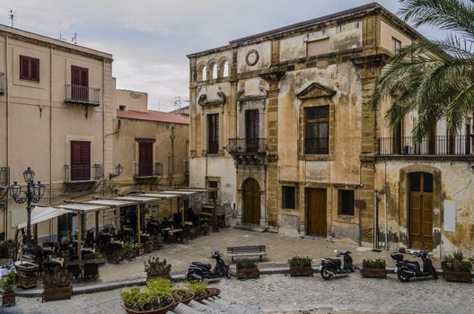 old typical constructions of the village of Monreale surrounding a small square in Sicily near the city of Palermo