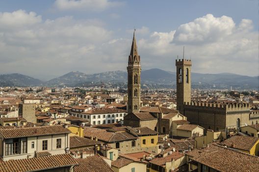 View of the city of Florence where the towers of the badia and the national museum stand Bargello in the background are the mountains of the tuscany