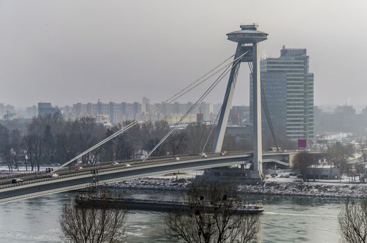 The Danube crossed by the new bridge of Bratislava a day of fog snow and intense cold