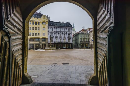 Historical center of Bratislava you can see the old town hall's gates the main square the fountain of Maximilian and a sculpture of Napoleon leaning on a bench and the dome of St. Martin Cathedral