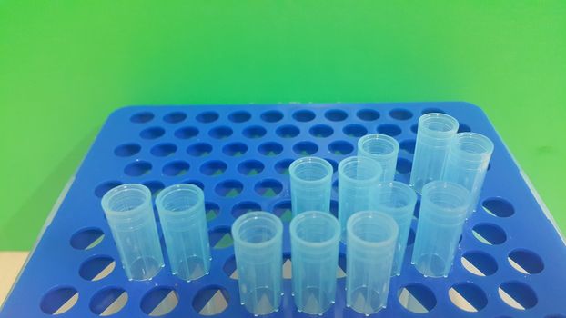 Close up view of blue micro litre tips in microtip box with empty holes. Reseach lab. tool for accurate measurement.