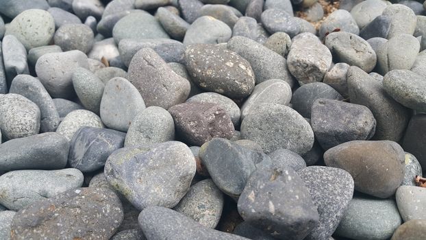 Rock Pebbles, small, rounded, smooth rocks. Texture background for text.