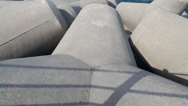 Close view of tetrapod stones on the sea shore to prevent coastal ersosion. Break water concrete tetrapods.
