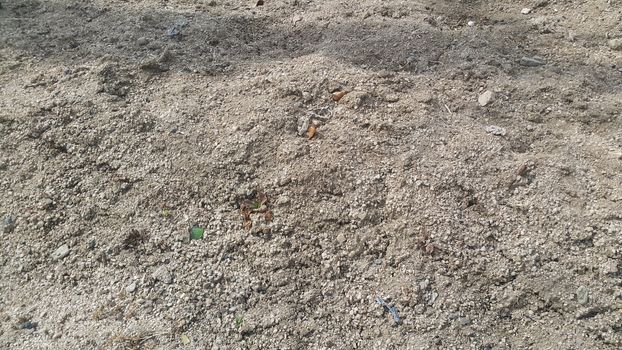 Close view of natural background of a field for farming. Dry agricultural brown soil detailed. 