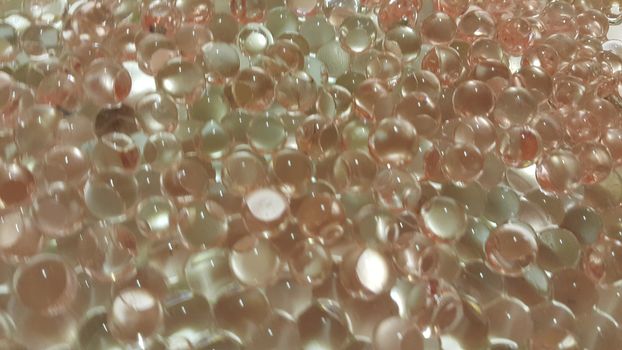 Closeup view with selective focus of shiny glittering orbeez or colorful water balls hydrogel. Water beads orbeez background.