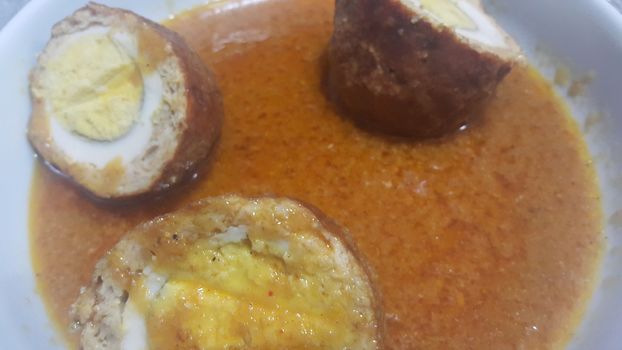 Top view of home made meat balls or meat kofta curry served in plate with cooked eggs