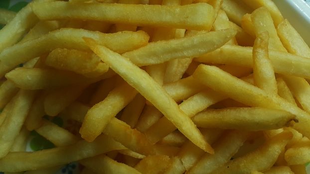 Closeup view of potato french fries or roasted slices with copy space for text