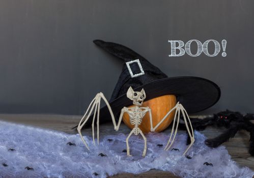 Boo happy halloween greeting text over dark wooden and Blackboard background.