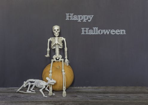 Happy halloween greeting text over dark wooden and Blackboard background