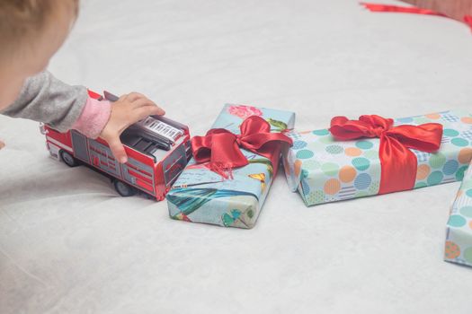 A child plays with cars that he just received as a gift.