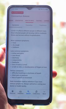 mobility and modern lifestyle concept: human reading a Covid information on mobile screen