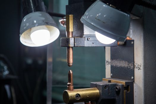 close-up view of spot welder tips device with two lamps.