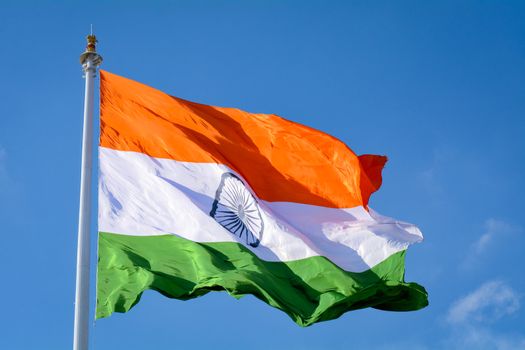 Indian flag waving in a air on independence day of india. With natural blue sky and cloud background along with aircraft