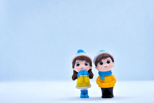 Tourism and travel concept: Miniature little boy and girl standing in isolated background