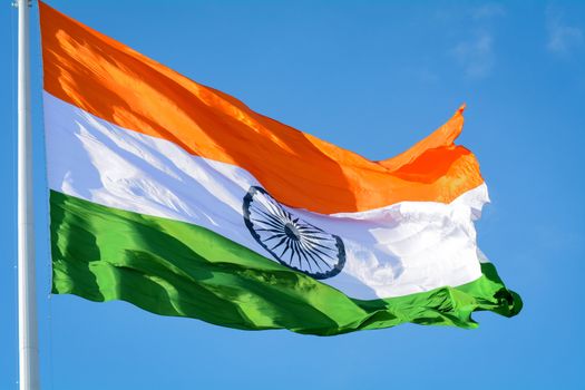 Indian flag waving in a air on independence day of india. With natural blue sky and cloud background along with aircraft