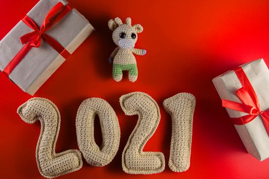 New year background with chroched toy bull symbol of chinese new year 2021 with craft paper gift boxes
