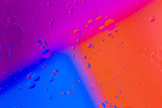 abstract colorful background of oil on water surface - closeup with selective focus and blur.