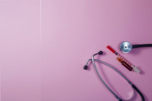 Covid-19, coronavirus treatment. Pills, stethoscope and medical masks, vaccine on pink background.