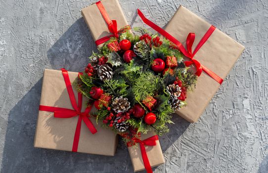 .Christmas background with gifts tied with a red ribbon and decorative wreath