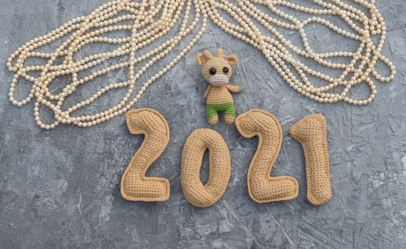 New year background with knitted toy bull symbol of chinese new year 2021