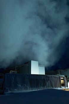 Night view. Thermal power plant building at a hot spring. Icelandic industry.