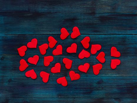 .Romantic valentine's day background red satin hearts on dark blue wooden backdrop