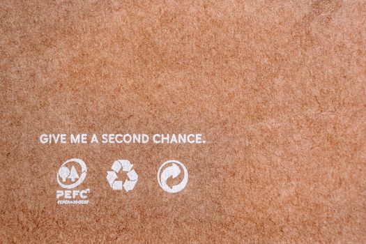 Reuse background. Words on craft paper. Recycle icons on brown paper. Give me a second chance. World resources concept. Reusing paper-based products. Ecological problems. Reusing concept.