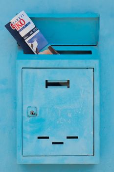 Mailbox with magazine, journal inside of it. Postal service concept. Safety of personal data background. Mail drop with newspaper, magazine. Mail doors background. Advertising concept