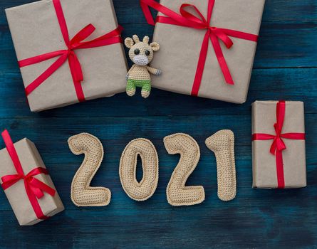 New year background with chroched toy bull symbol of chinese new year 2021 with craft paper gift boxes