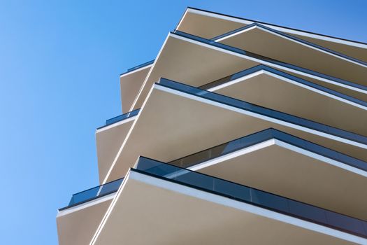 Modern building. Modern hotel building with facade of concrete and glass. Modern skyscraper steel and glass architecture. Architectural minimalism of facade. Unusual facade of contemporary house.