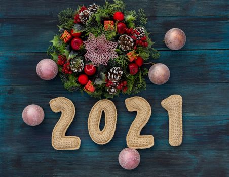 .Christmas background with knitted numbers 2021 and decorative wreath