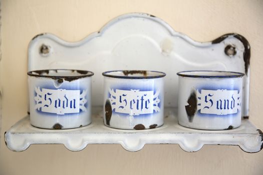 Old enamel mugs on a shelf in the kitchen