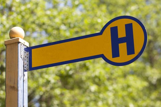 German wooden blank bus stop sign in nature