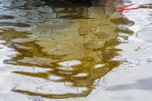 Ecological catastrophy. Spill of oil products into the sea. Poisonous oil products float on the surface of the clean sea.