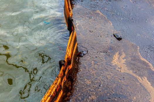 Ecological catastrophy. Spill of oil products into the sea. Poisonous oil products float on the surface of the clean sea.