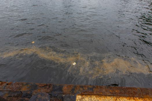 Ecological catastrophy. Spill of oil products into the sea. Poisonous oil products float on the surface of the clean sea.