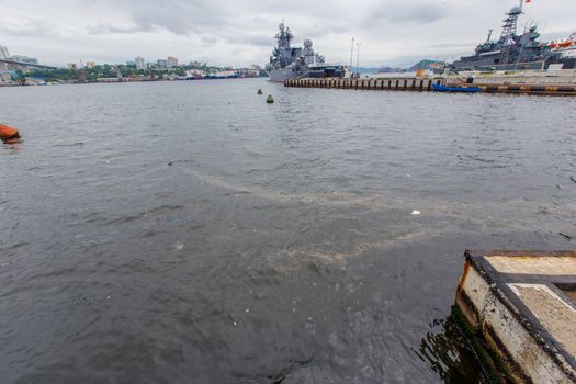 Environmental disaster. Spill of oil products into the sea. Dirty water area of the Golden Horn Bay in Vladivostok