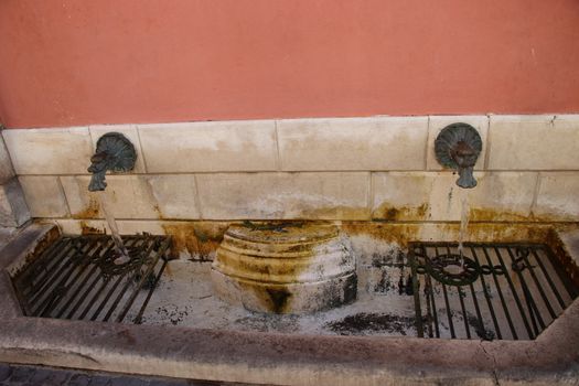 Historic iron fountain  in Gargnano on lake Garda in Brescia in  Italy
