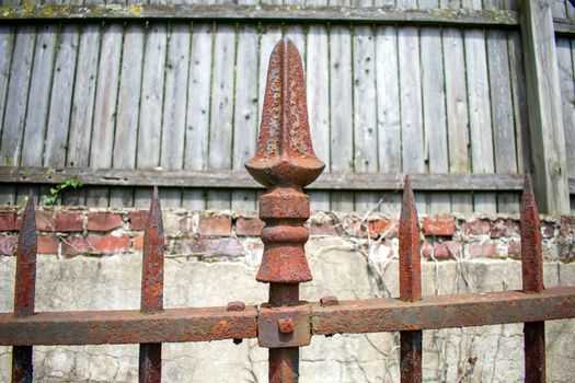 A Rusty Spike on an Old Black Metal Fence