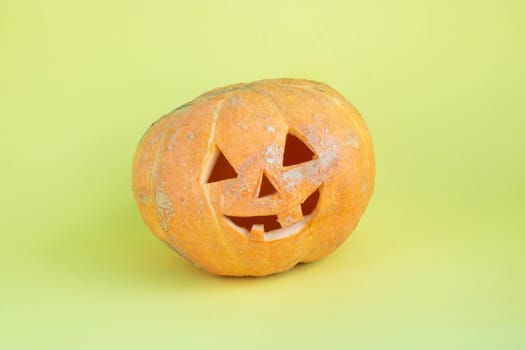 Funny pumpkin on a yellow background.The concept of Halloween.