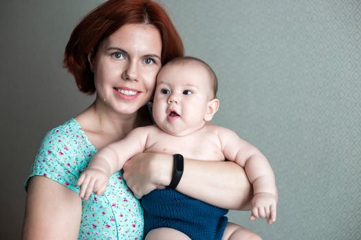 mom holds her little son in her arms.