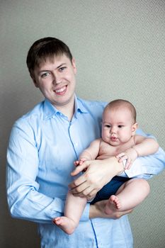 close-up portrait of a toddler boy in the arms of dad